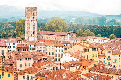 Aerial cityscape view on the old town of Lucca with San Frediano basilica tower in Italy