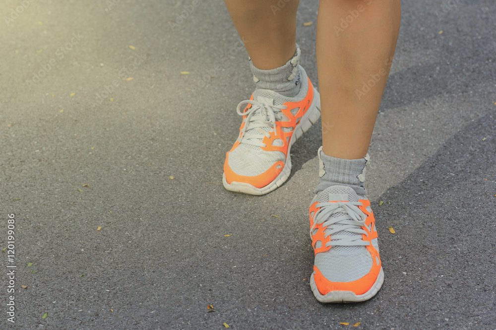 young fitness woman legs walking on park