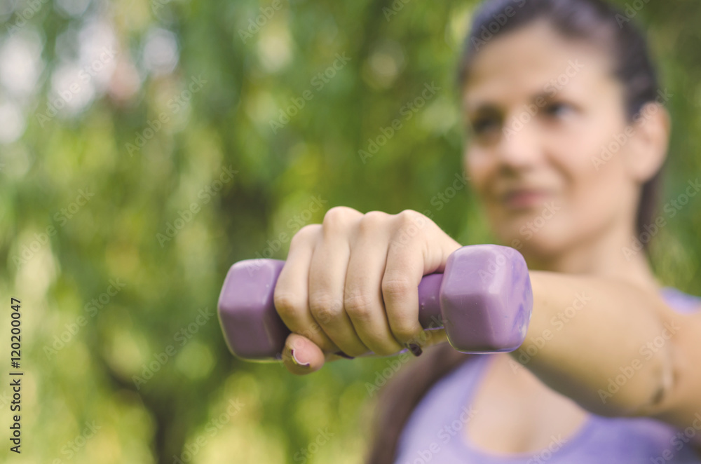 woman doing exercises with wrist weights woman doing exercises with wrist weights