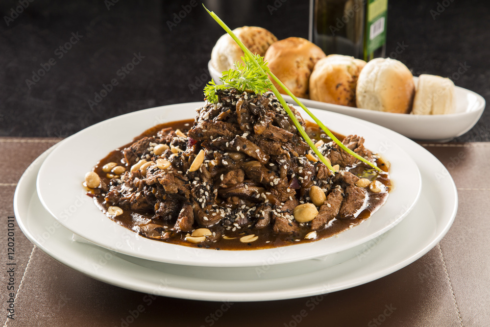 portion of meat with almond sauce. portion of meat with almond sauce.
