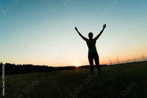Runner woman raising arms up, success concept