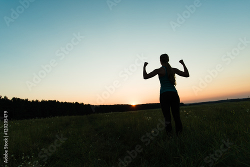 Runner woman raising arms up, success concept