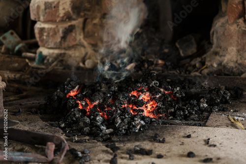 Close-up of fire burning down in furnace at workshop