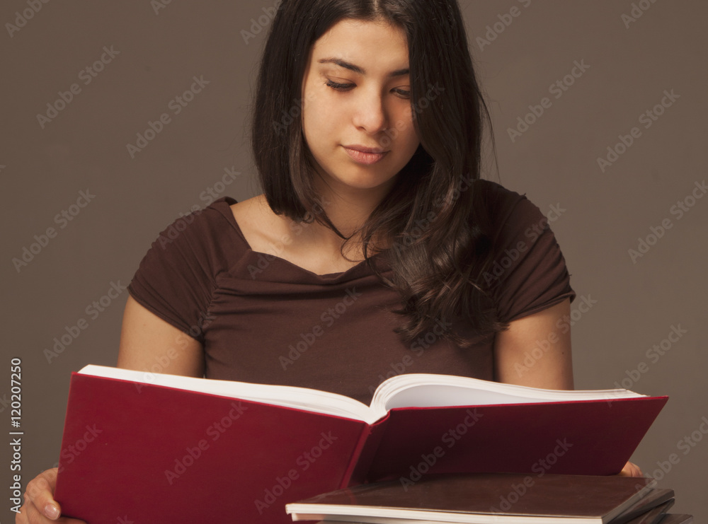 young beautiful girl reading a book intdoors (education, self de young beautiful girl reading a book intdoors (education, self de