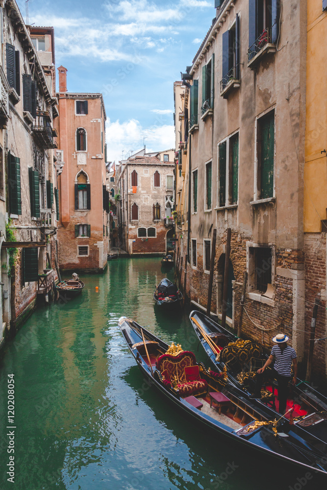 Canal, gondolas and houses in Venice