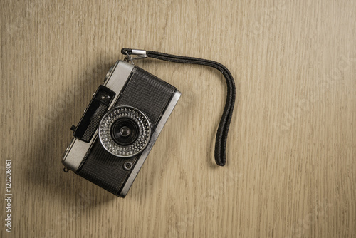 top view of retro camera on wooden table