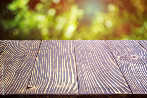 Wooden deck table over beautiful bokeh background