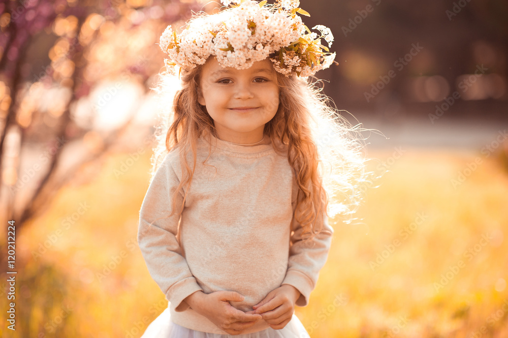 Smiling baby girl 4-5 year old wearing floral hairband over nature  background. Posing outdoors looking at camera. Stock Photo | Adobe Stock