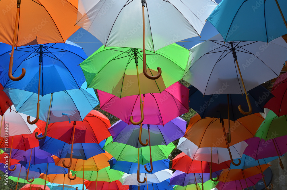 Opened umbrellas of different colors shot from underneath