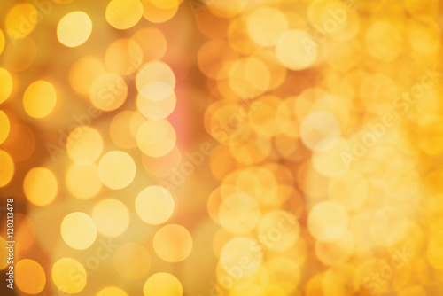 Christmas abstract shiny bokeh in yellow golden colors, new year illunination. Seasonal vintage hipster holiday background.