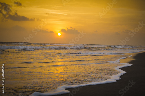 Sunset on the beach with waves crashing