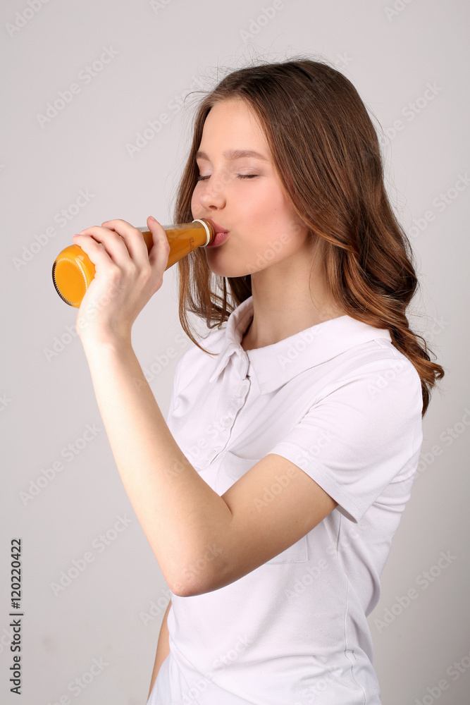 Lady drinking orange fresh. Close up. White background Lady drinking orange fresh. Close up. White background