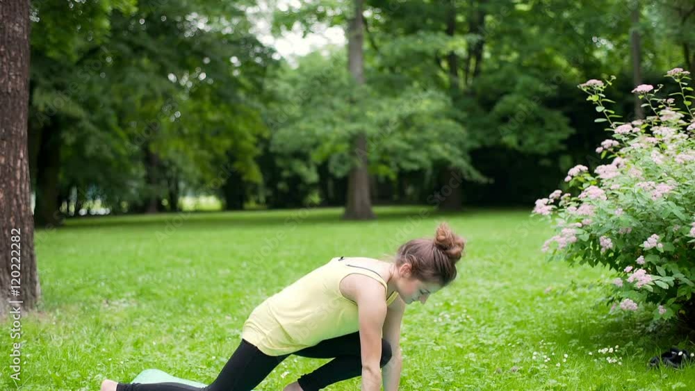 Girl standing on the mat in the park and doing exercises, steadycam shot
Girl standing on the mat in the park and doing exercises, steadycam shot