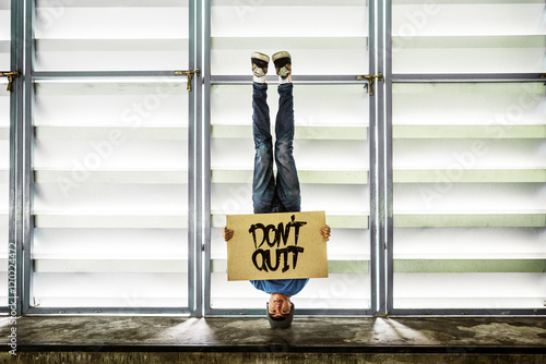 Man Holding Speech Sign Don't Quit Cocncept photo