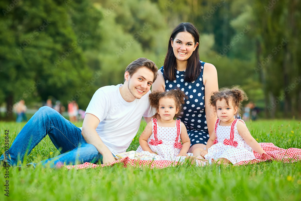 Happy family in the park summer, autumn. Parents and two daughte Happy family in the park summer, autumn. Parents and two daughte