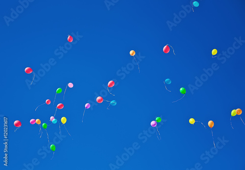 Lots of colorful balloons flying on blue sky