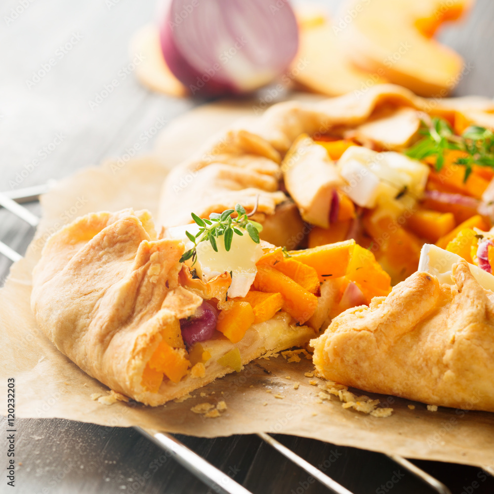 Homemade crostata pie with pumpkin, apples and cheese on rustic dark background, selective focus. Effect toning Instagram Homemade crostata pie with pumpkin, apples and cheese on rustic dark background, selective focus. Effect toning Instagram