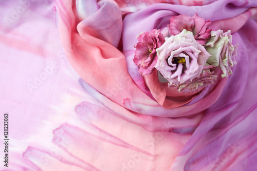 Flowers on colored silk background.