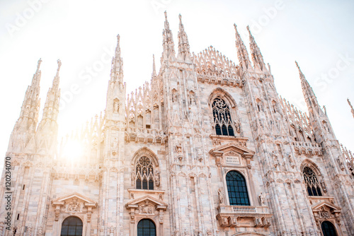 Fotografia Main facade of the famous Duomo cathedral on the sunrise in Milan city in Italy