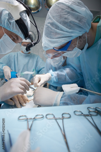 Four surgeons working in operating room