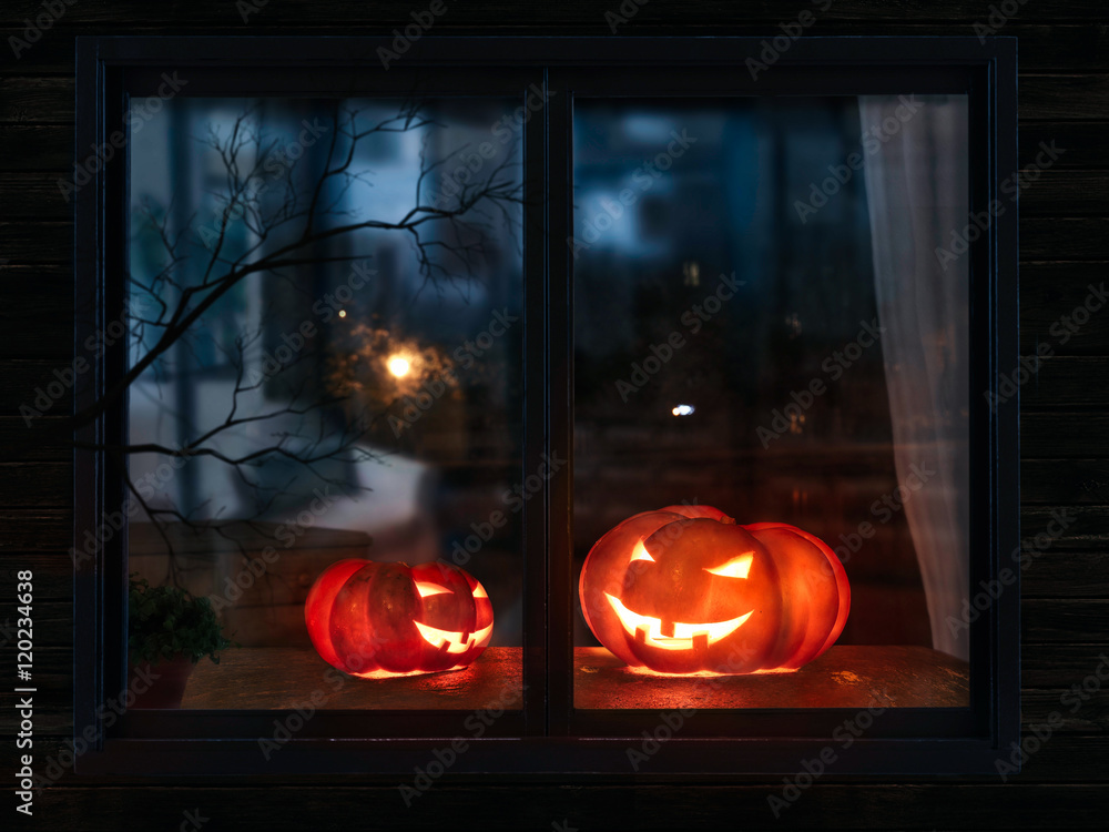 Obraz premium Halloween pumpkin in the mystical house window at night