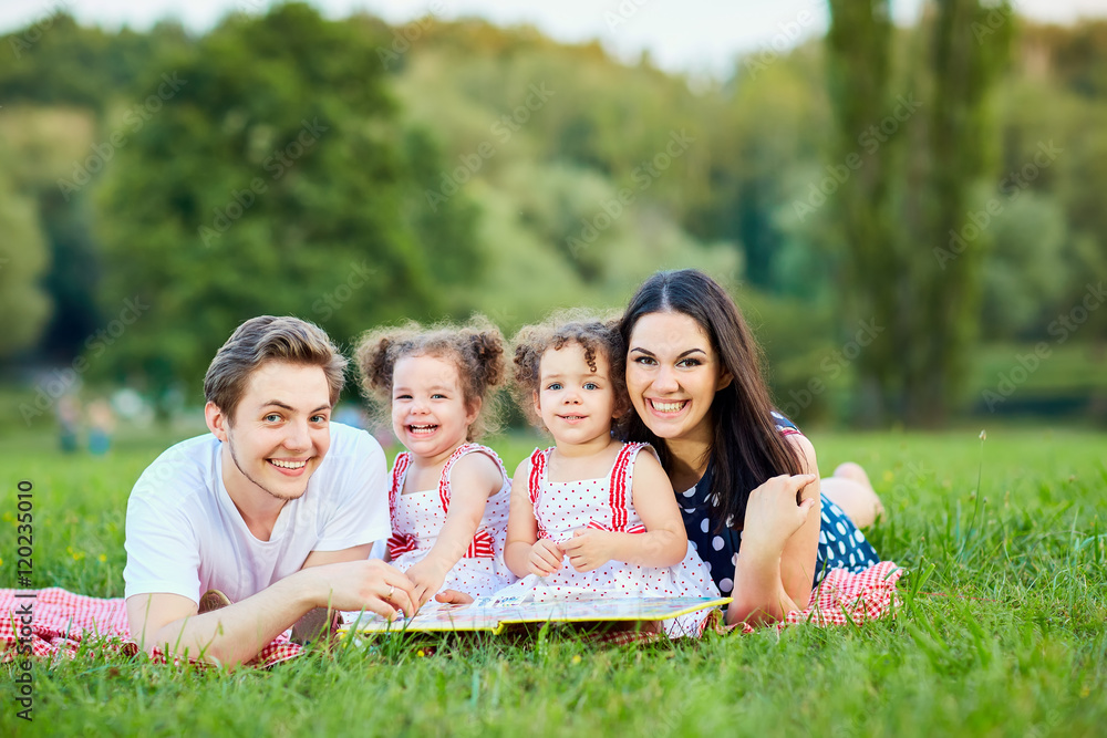 Happy family in the park summer, autumn. Parents and two daughte Happy family in the park summer, autumn. Parents and two daughte