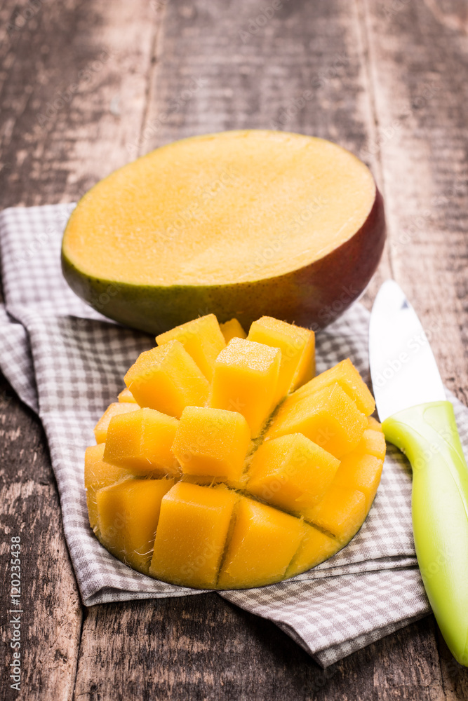 Fresh rip mango on a wooden background.Healthy food Fresh rip mango on a wooden background.Healthy food