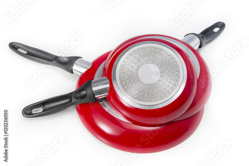 Set of induction frying pans of different sizes made of press aluminium, red colored. Isolated on white