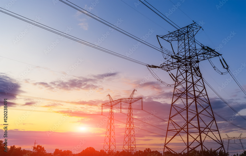 Electricity pylons and lines beautiful sky and the sunset over the horizon.