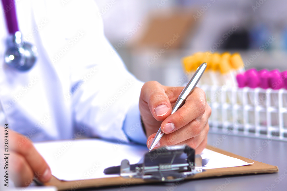 Fototapeta premium doctor at his desk working with medical equipment in the background