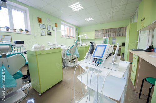 Stomatology equipment and instruments in dentist's office on the background of dental chairs and other equipment used by dentists
