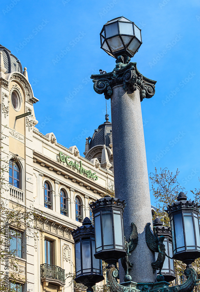 Old tall street lamp on the Catalonia square in Barcelona, Spain Old tall street lamp on the Catalonia square in Barcelona, Spain