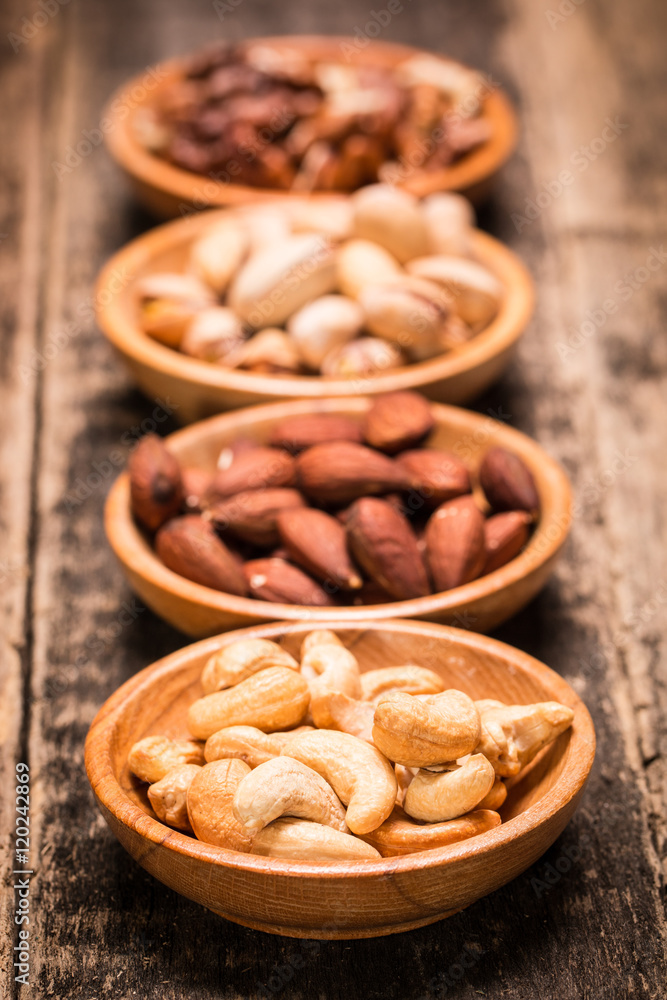 Mix nuts on wooden table,healthy vegan food. Mix nuts on wooden table,healthy vegan food.