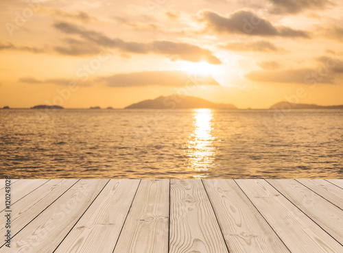 Tropical beach in sunset with wooden planks floor background © SasinParaksa