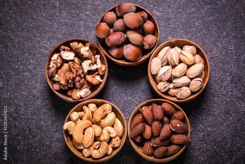 Mix nuts on wooden table,healthy vegan food. Mix nuts on wooden table,healthy vegan food.