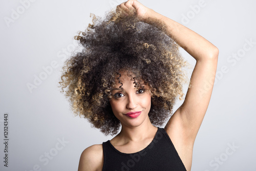 Young black woman with afro hairstyle smiling photo