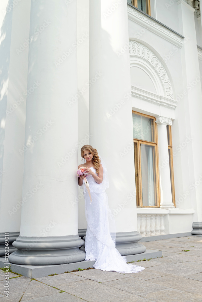Beauty bride in bridal gown with bouquet and lace veil in the nature. Beautiful model girl in a white wedding dress. Female portrait in the park. Woman with hairstyle. Cute lady outdoors Beauty bride in bridal gown with bouquet and lace veil in the nature. Beautiful model girl in a white wedding dress. Female portrait in the park. Woman with hairstyle. Cute lady outdoors