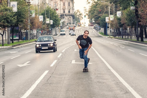 Professional skateboarder riding a skateboard slope on the capital city streets © guruXOX