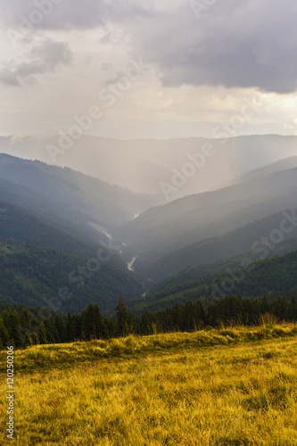 beautiful mountain landscape with a valley under cloudy sky in C