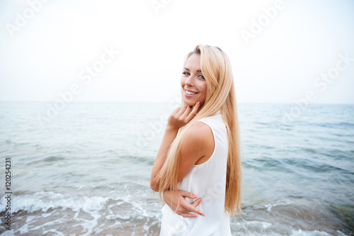 Smiling woman standing on the seaside