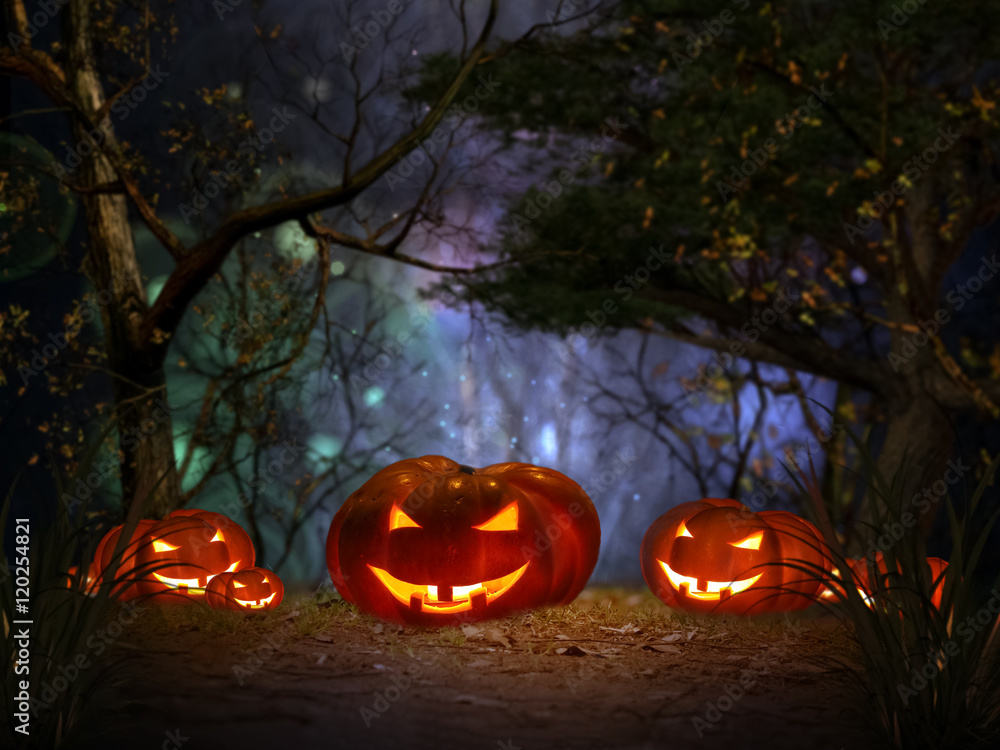 Halloween pumpkin in a mystical forest at night Halloween pumpkin in a mystical forest at night
