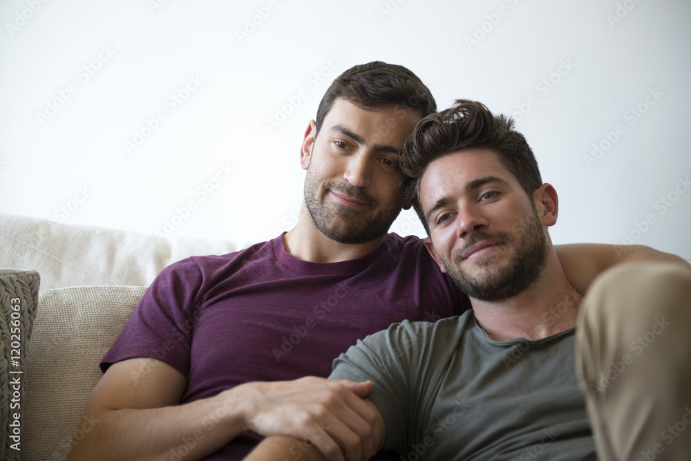 Gay Male Couple Relax On Sofa Watching TV Gay Male Couple Relax On Sofa Watching TV