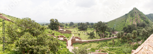 The historical ruins of the now famous Bhangarh Fort with ruins of temples, shops, gates and ramparts in the Rajgarh municipality of the Alwar district in the state of Rajasthan in India  photo