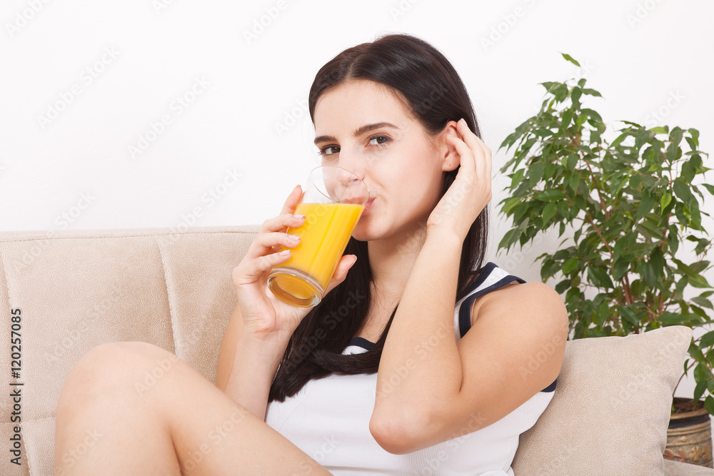 Woman drinking orange juice Beautiful mixed-race Asian, Caucasian model. Woman drinking orange juice Beautiful mixed-race Asian, Caucasian model.