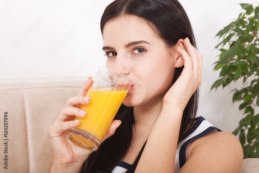 Woman drinking orange juice Beautiful mixed-race Asian, Caucasian model. Woman drinking orange juice Beautiful mixed-race Asian, Caucasian model.