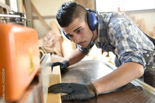 Young man in woodwork training course