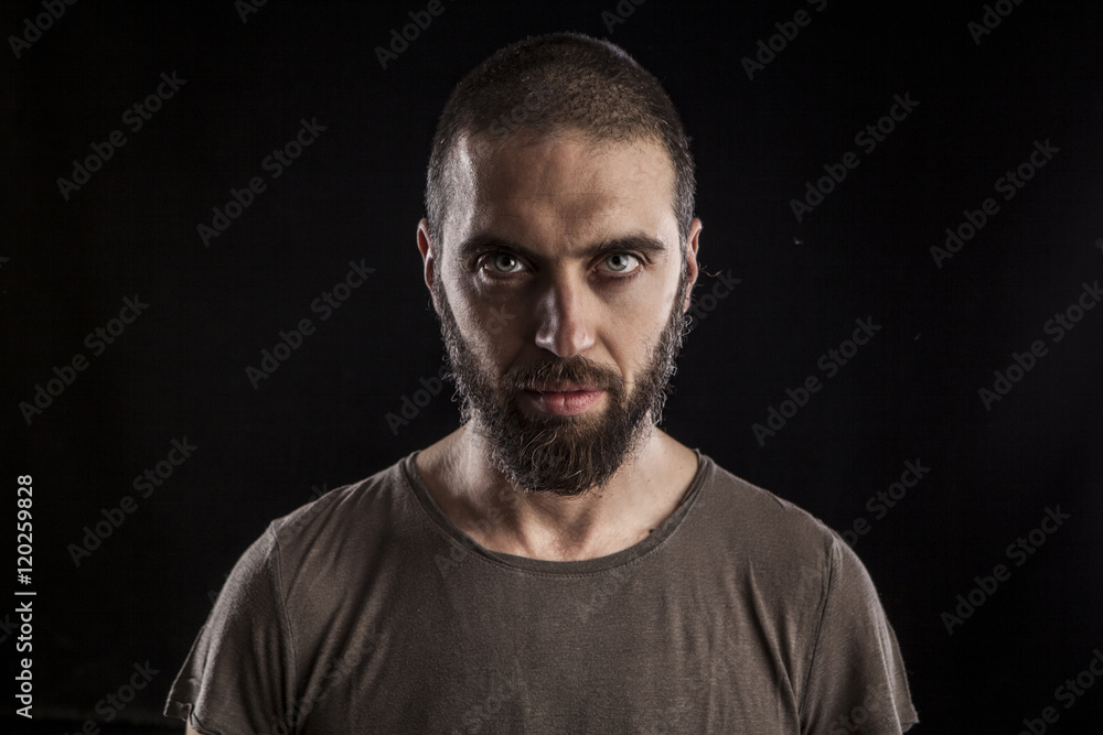 portrait of a handsome bearded man on dark background