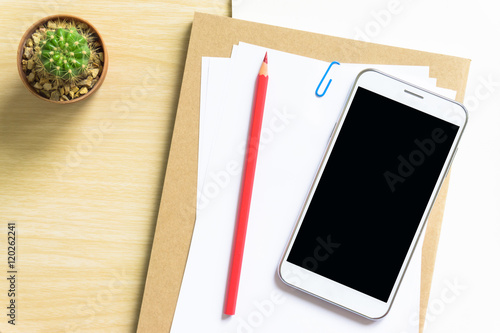 blank paper, pencil, and smart phone on wood desk © NOKFreelance