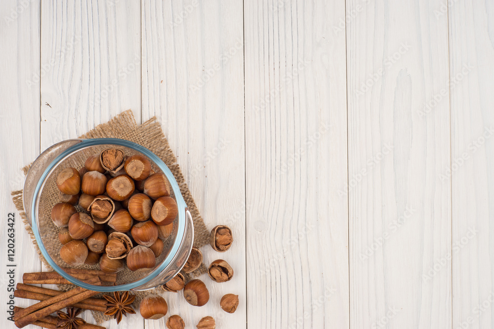 Hazelnut in a glass bowl on the old wooden table. Hazelnut in a glass bowl on the old wooden table.
