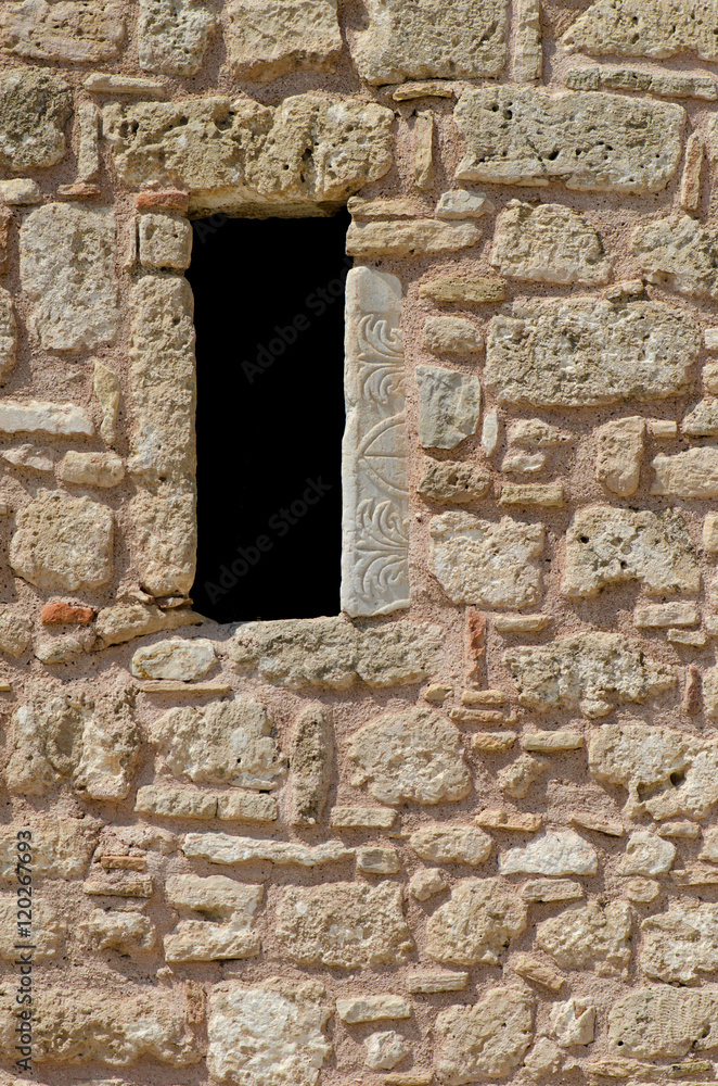 Ancient old ruined stone wall and open window